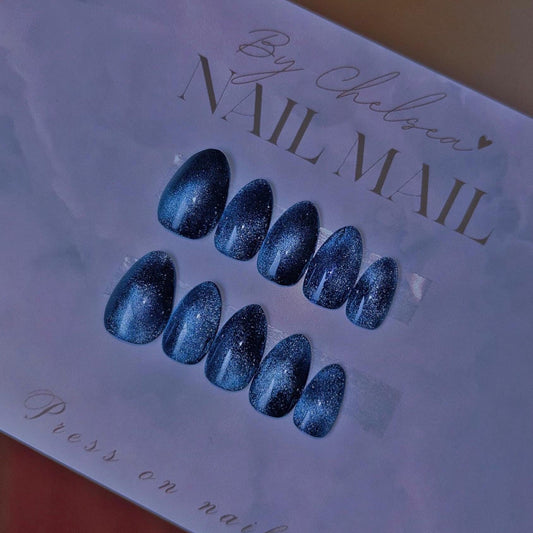 Blue cat eye gel nails in short almond 